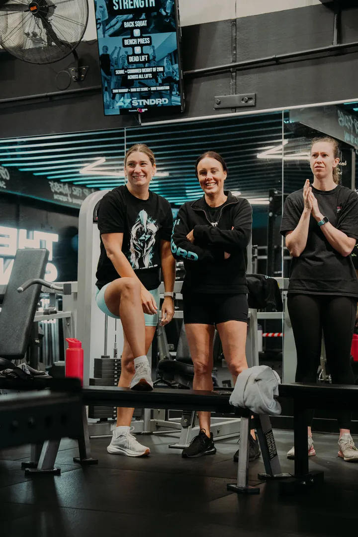 Teammates clapping a member through her step-ups