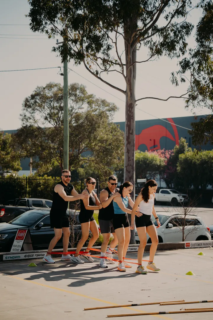 A relay team running outside the studio
