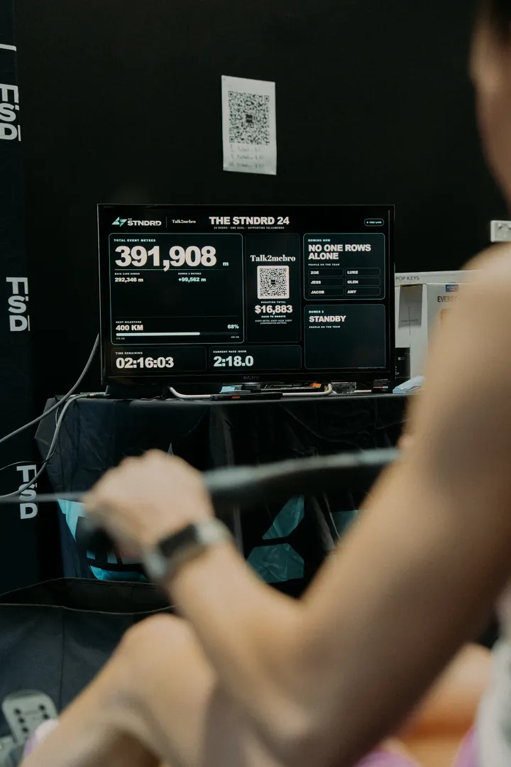 A member rowing beside the live metres board