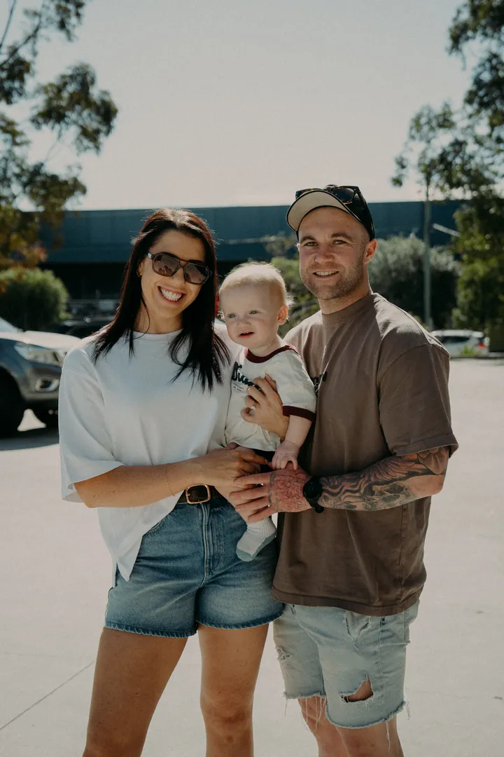 A couple with their baby outside the studio