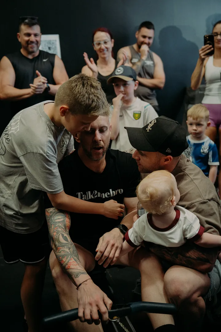 A rower with family and kids cheering him on