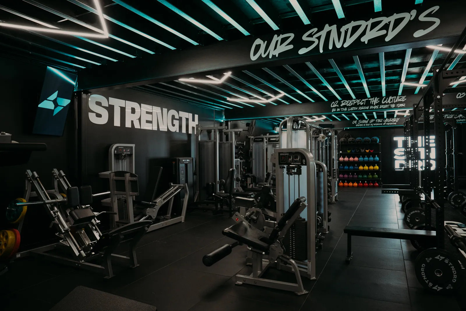 Hammer Strength and Life Fitness machines under the STRENGTH wall